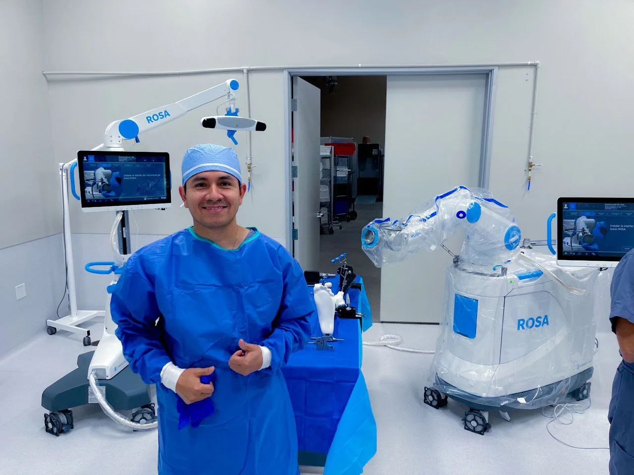 Dr. Galvis next to the ROSA robotic system